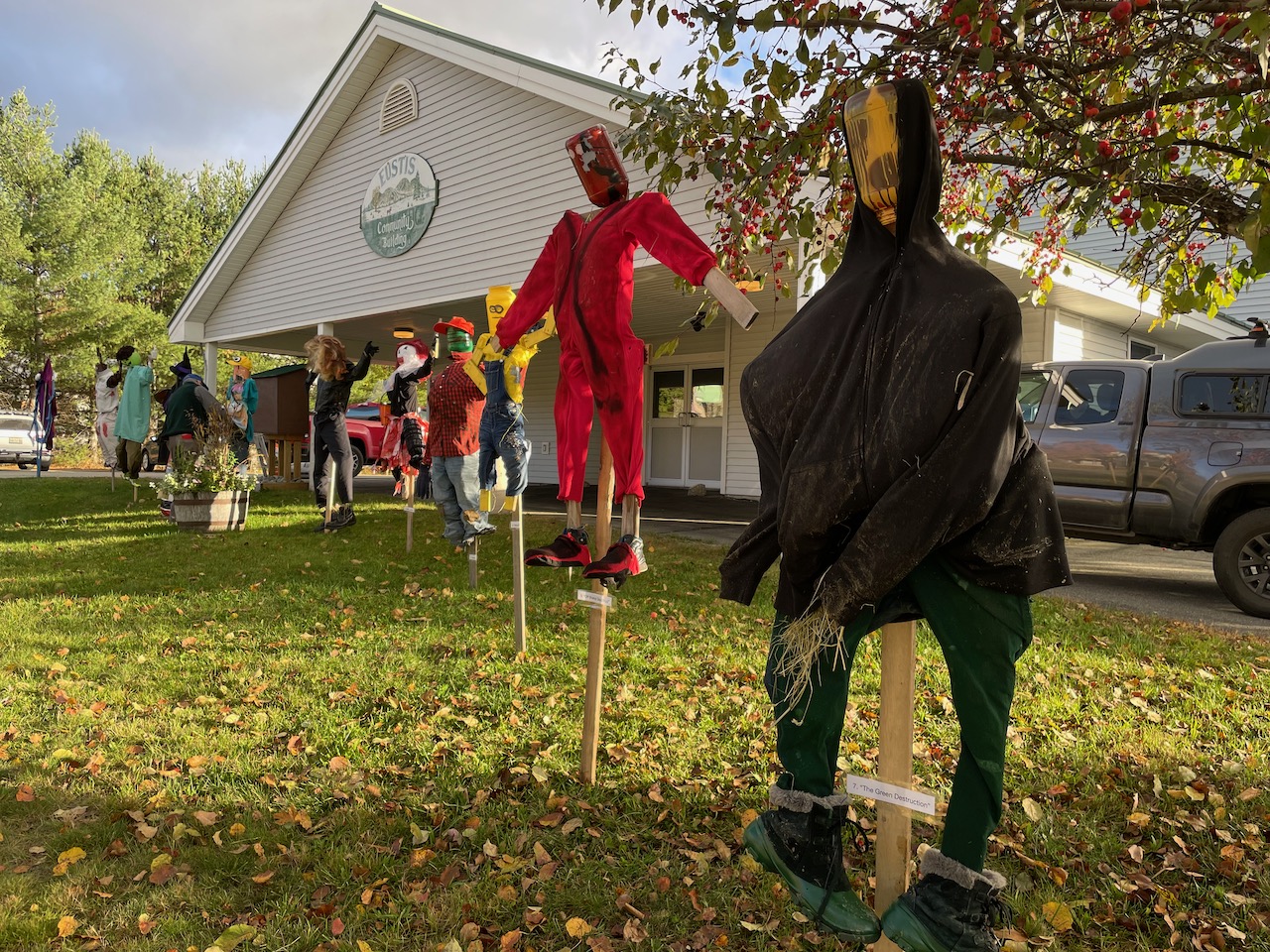 Scarecrows on display at community building.